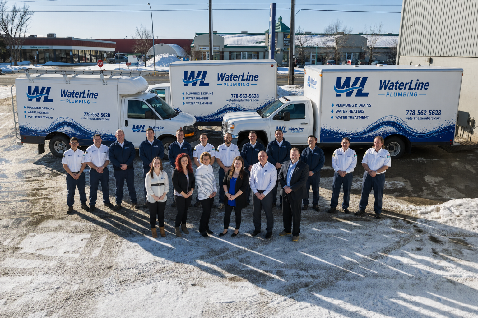 WaterLine Plumbing staff and box-truck fleet outside the Surrey BC headquarters